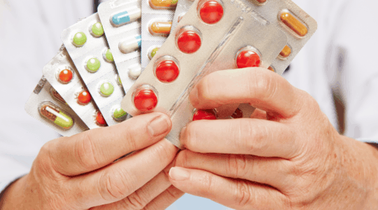 pharmacist-holding-prescriptions